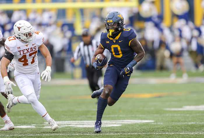 Nov 20, 2021; Morgantown, West Virginia, USA; West Virginia Mountaineers wide receiver Bryce Ford-Wheaton (0) makes a catch and runs for extra yards during the first quarter against the Texas Longhorns at Mountaineer Field at Milan Puskar Stadium.